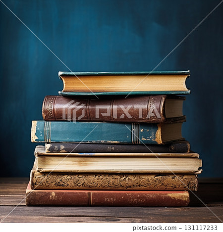 Stacks of old books on the table. Antique books with a blue background. 131117233