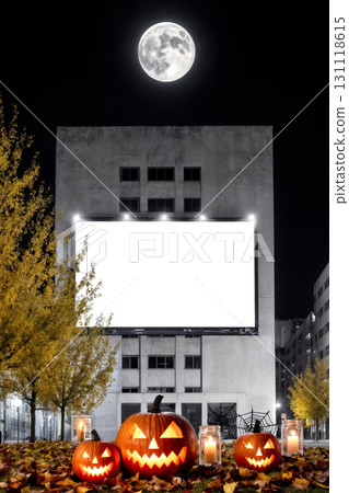 white billboard on building facade at night with jack o lantern on grass, halloween holiday concept 131118615