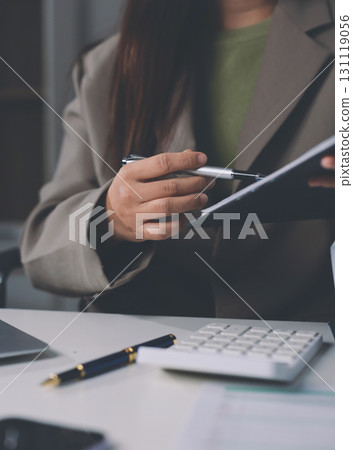 Portrait of young Hispanic professional business woman standing in office. Happy female company executive, smiling businesswoman entrepreneur corporate leader manager looking at camera using tablet Portrait of young Hispanic professional business woman standing in office. Happy female company executive, smiling businesswoman entrepreneur corporate leader manager looking at camera using tablet 131119056