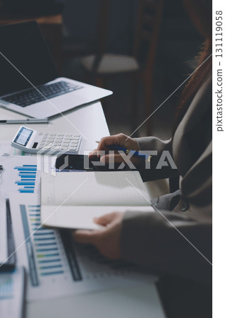 Portrait of young Hispanic professional business woman standing in office. Happy female company executive, smiling businesswoman entrepreneur corporate leader manager looking at camera using tablet Portrait of young Hispanic professional business woman standing in office. Happy female company executive, smiling businesswoman entrepreneur corporate leader manager looking at camera using tablet 131119058