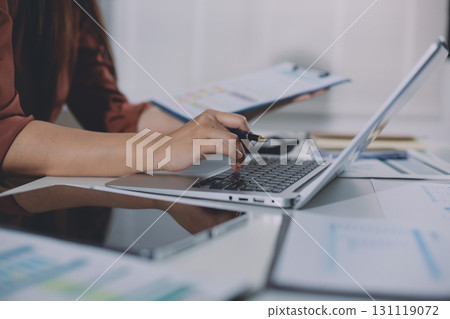 Portrait of young Hispanic professional business woman standing in office. Happy female company executive, smiling businesswoman entrepreneur corporate leader manager looking at camera using tablet 131119072