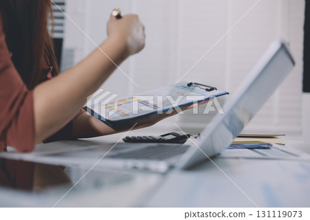 Portrait of young Hispanic professional business woman standing in office. Happy female company executive, smiling businesswoman entrepreneur corporate leader manager looking at camera using tablet Portrait of young Hispanic professional business woman standing in office. Happy female company executive, smiling businesswoman entrepreneur corporate leader manager looking at camera using tablet 131119073