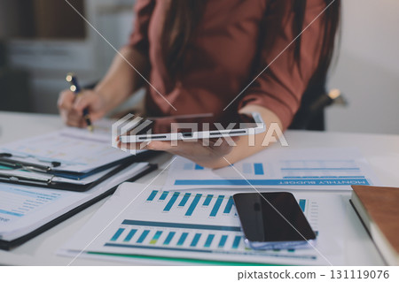 Portrait of young Hispanic professional business woman standing in office. Happy female company executive, smiling businesswoman entrepreneur corporate leader manager looking at camera using tablet 131119076