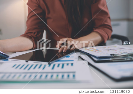 Portrait of young Hispanic professional business woman standing in office. Happy female company executive, smiling businesswoman entrepreneur corporate leader manager looking at camera using tablet Portrait of young Hispanic professional business woman standing in office. Happy female company executive, smiling businesswoman entrepreneur corporate leader manager looking at camera using tablet 131119080