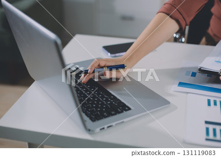 Portrait of young Hispanic professional business woman standing in office. Happy female company executive, smiling businesswoman entrepreneur corporate leader manager looking at camera using tablet 131119083