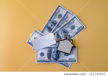 Blank tag sale with miniature houses board on bank note. 131120243