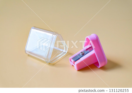 Pink pencil-sharpener on a over color background. 131120255