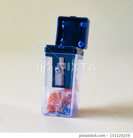 Black pencil-sharpener on a over color background. 131120259