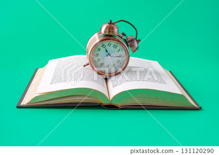 Alarm clock on the book.Time for knowledge. Alarm clock on the book.Time for knowledge. 131120290