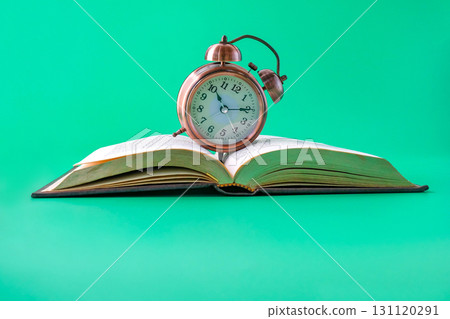 Alarm clock on the book.Time for knowledge. Alarm clock on the book.Time for knowledge. 131120291