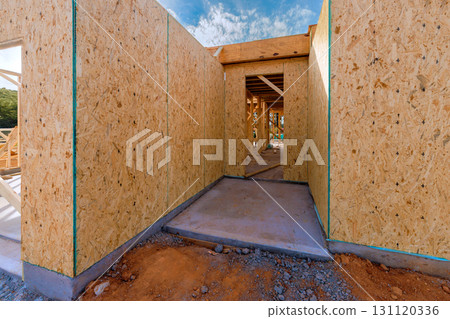 Unfinished walls frame an entrance at during build new house construction area 131120336