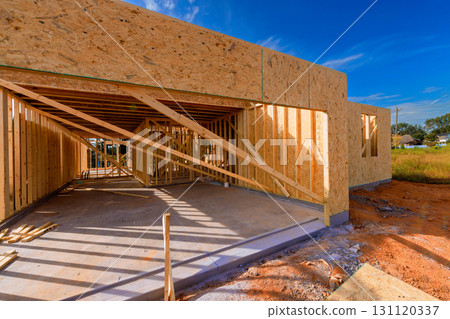 Wooden frames are being set up for new house under work day in residential area Wooden frames are being set up for new house under work day in residential area 131120337