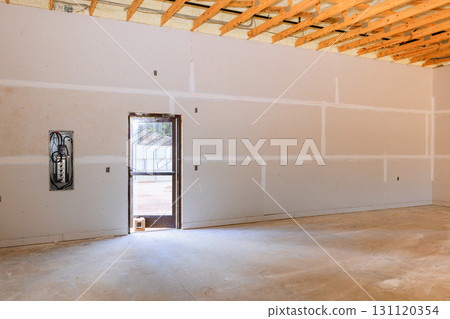 Renovation work is underway in this construction space with an open door letting in natural light. 131120354