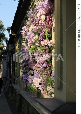 Artificial flowers on the facade of the building. Artificial flowers on the facade of the building. 131120584