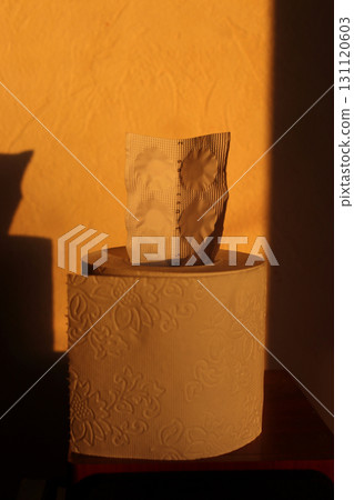 The pill blaster is sticking out of the toilet paper. 131120603
