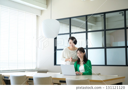 Female colleagues working in the office Female colleagues working in the office 131121120
