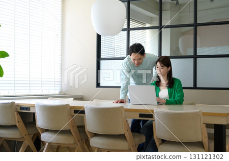 Japanese men and women working in the office 131121302
