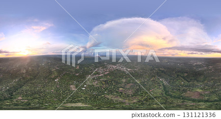 Vibrant sunset over lush valley with distant mountains Vibrant sunset over lush valley with distant mountains 131121336
