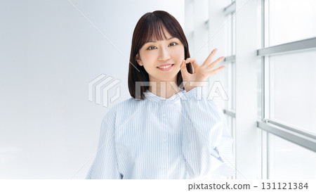 Smiling business woman doing OK pose 131121384