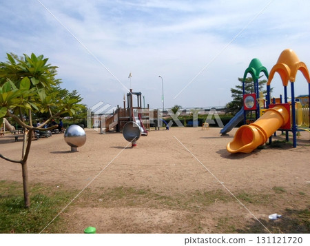 A Spacious Playground with Slides and Climbing Structures Under a Bright Blue Sky 131121720