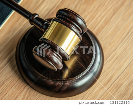 A wooden judge's gavel on a polished table, symbolizing law and justice. A wooden judge's gavel on a polished table, symbolizing law and justice. 131122315