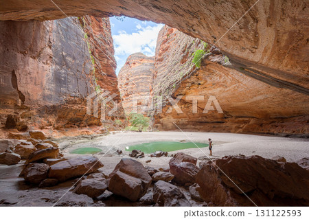 A person explores a stunning natural gorge in Western Australia.. A person explores a stunning natural gorge in Western Australia.. 131122593