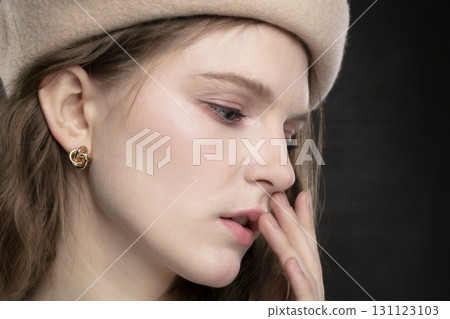 Girl's face close-up in profile with gold earrings. Girl's face close-up in profile with gold earrings. 131123103