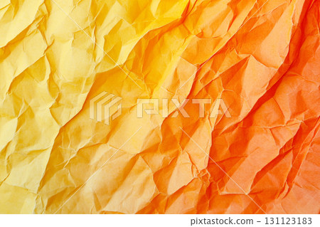 A vibrant yellow, close-up view of a crumpled piece of paper, showing a highly textured surface with numerous folds, creases, and shadows. 131123183