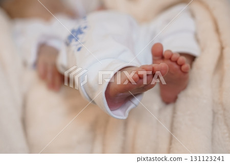 Tender Baby Feet Held in Mother's Arms, Close-Up Shot with Cream Robe and Blue Pajamas, Soft Pastel Color Palette 131123241