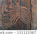 Close view of a tree trunk surface without bark displays unique textures and patterns. The natural wood grains create beautiful waves, reflecting the tree's age and history. 131123367