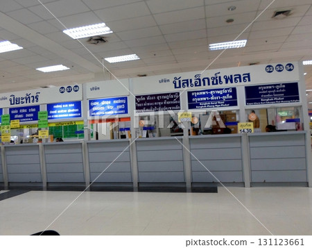 A Row of Check In Counters with Thai Signs and Timetables in a Bright Terminal 131123661