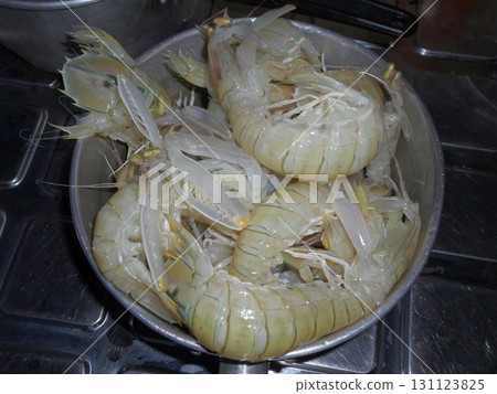 A Metal Pot Filled with Cooked Shrimp Ready to Serve in a Tropical Kitchen on a Stove 131123825