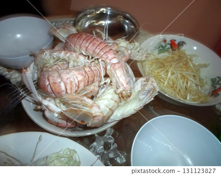 A Table with a Bowl of Fresh Shrimp and Bean Sprouts Ready for a Meal in a Tropical Dining Area 131123827