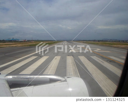 A View of the Runway Markings and Engine Through an Airplane Window During Taxiing A View of the Runway Markings and Engine Through an Airplane Window During Taxiing 131124325