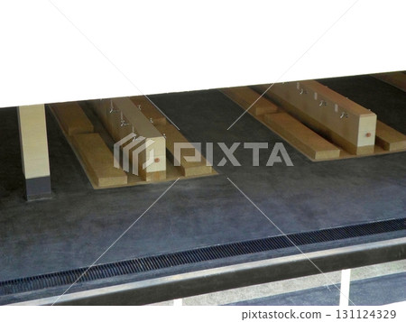 Indoor Shower Area with Wooden Benches and Drainage System in a Public Facility 131124329