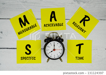 SMART Abbreviations of Specific, Measurable, Achievable, Relevant, Time text written on sticky note and alarm clock flat lay on wooden background SMART Abbreviations of Specific, Measurable, Achievable, Relevant, Time text written on sticky note and alarm clock flat lay on wooden background 131124397