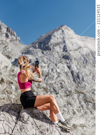 Woman Tourist Taking Pictures in High Mountains 131124535