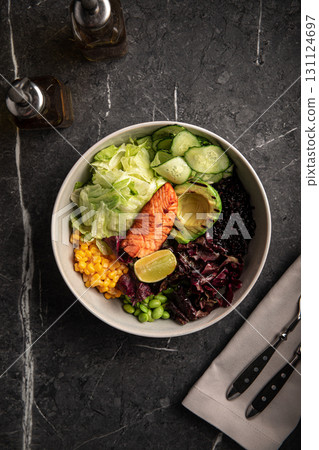Healthy poke bowl with salmon and vegetables 131124697