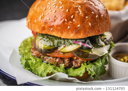 Tasty cheeseburger with fries, sauces and salad 131124705