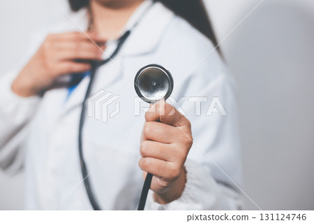 A young male doctor holding an stethoscope A young male doctor holding an stethoscope 131124746