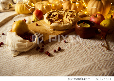 Autumn Thanksgiving Table With Pie, Fruit, Rustic Decor And Cozy Lights 131124824