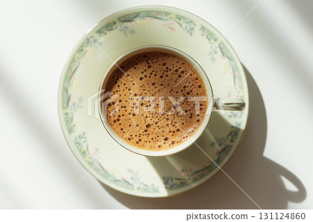 Minimalist Coffee Cup with Crema on Light Wooden Table under Sun Light Minimalist Coffee Cup with Crema on Light Wooden Table under Sun Light 131124860
