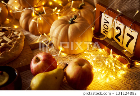 Autumn Harvest Table With Pumpkins, Apples, Fairy Lights, And A November Calendar, Cozy Home Scene 131124882