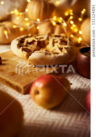 Cozy Autumn Thanksgiving Pie On Wooden Board With Apples And Warm Fairy Lights Cozy Autumn Thanksgiving Pie On Wooden Board With Apples And Warm Fairy Lights 131124891