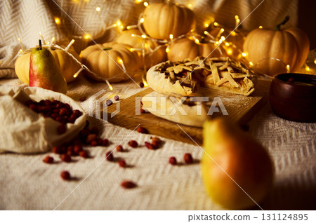 Warm Autumn Thanksgiving Table With Pies, Pumpkins, Pears And Fairy Lights 131124895