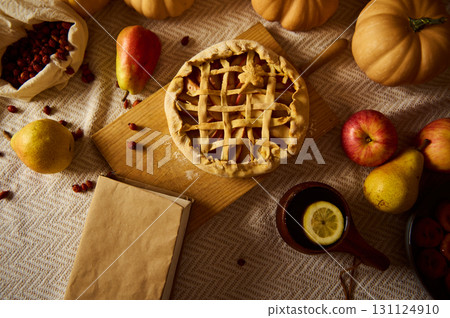 Autumn Thanksgiving Table With Pie, Pumpkins, Apples, and Pears on Wooden Board 131124910