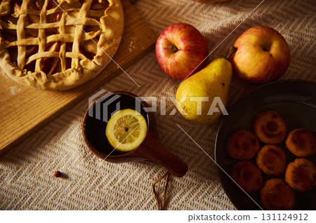 Autumn Harvest Table With Lattice Pie, Apples, Pears, Lemon Cup, And Dumplings Autumn Harvest Table With Lattice Pie, Apples, Pears, Lemon Cup, And Dumplings 131124912