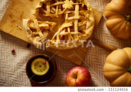 Cozy Autumn Thanksgiving Pie Scene With Lattice Crust, Pumpkins, Apple And Warm Drink 131124916