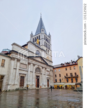 Annecy, France - February 09, 2024 Eglise Notre-Dame de Liesse in Haute-Savoie, Annecy. Large, stone church with a prominent bell tower under misty sky 131125022