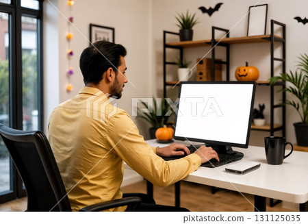 man working on a computer in a room decorated for halloween, monitor mockup 131125035